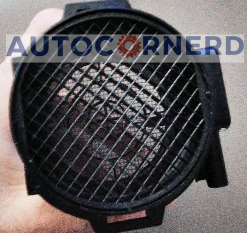MAF sensor housing with a protective mesh grid.